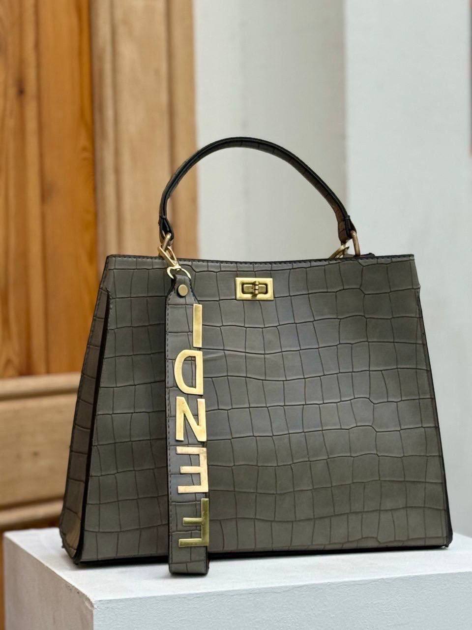 Fendi crocodile effect top handle bag with a gold tone Fendi strap