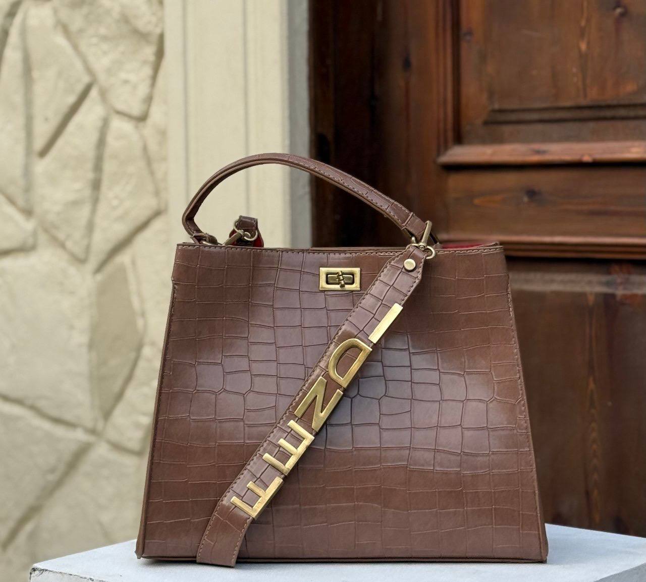 Fendi crocodile effect top handle bag with a gold tone Fendi strap