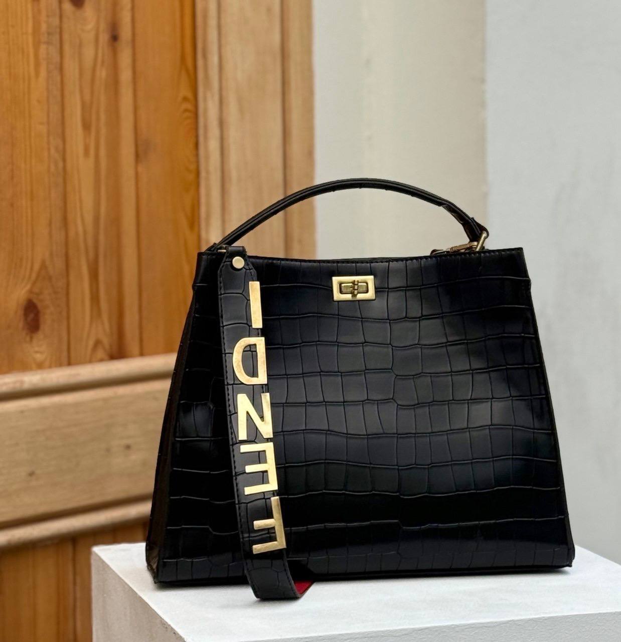 Fendi crocodile effect top handle bag with a gold tone Fendi strap