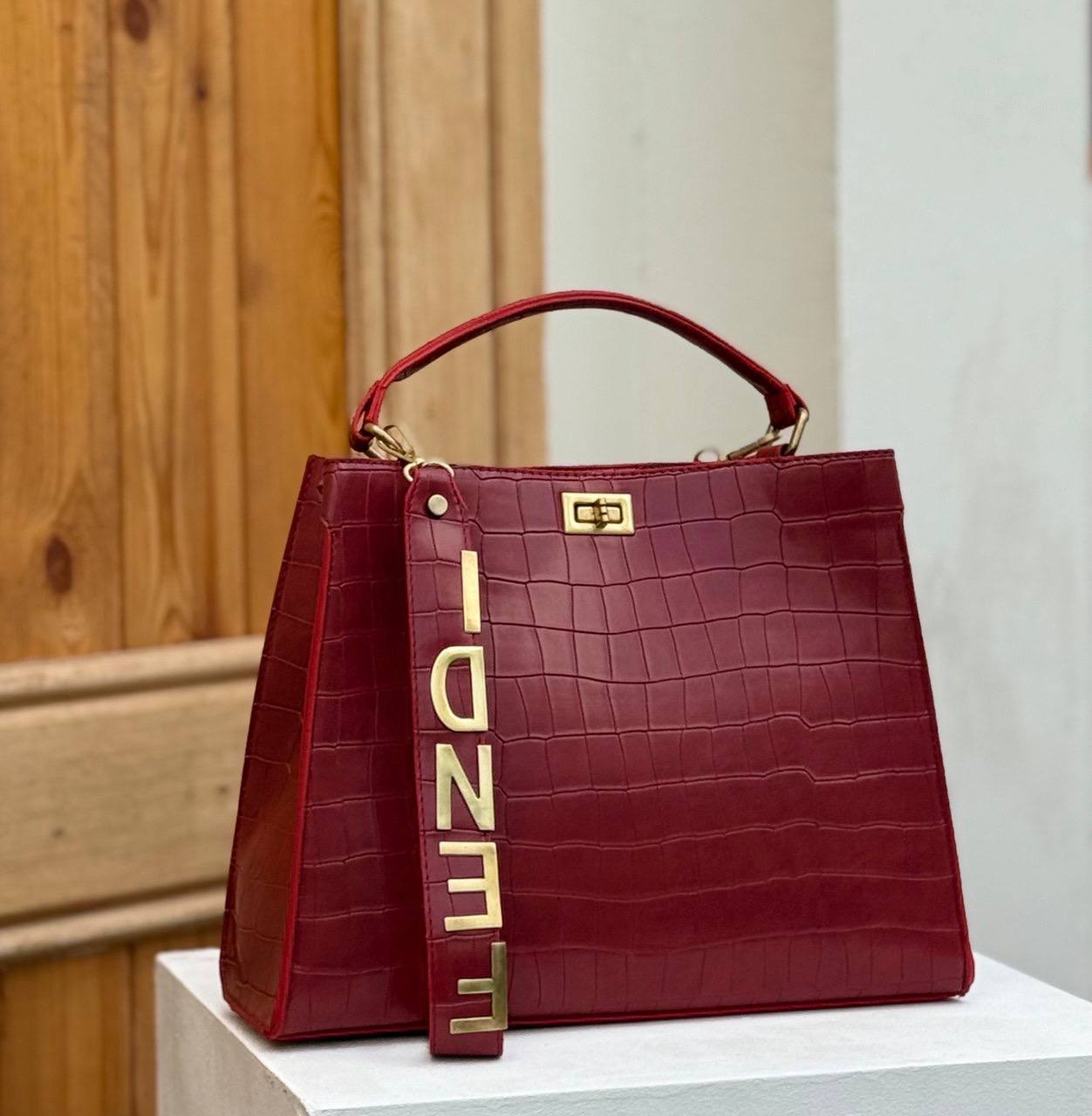 Fendi crocodile effect top handle bag with a gold tone Fendi strap